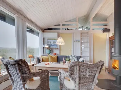 a living room with a couch and chairs and a fireplace at Holiday Home Eri - 300m from the sea by Interhome in Pandrup