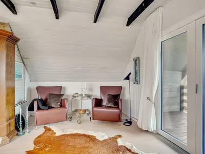 a living room with two chairs and a couch at Holiday Home Emiline - 250m from the sea by Interhome in Saltum