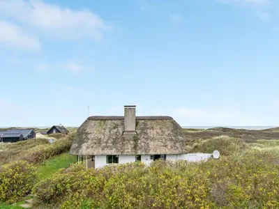 an old house in the middle of a field at Holiday Home Emiline - 250m from the sea by Interhome in Saltum