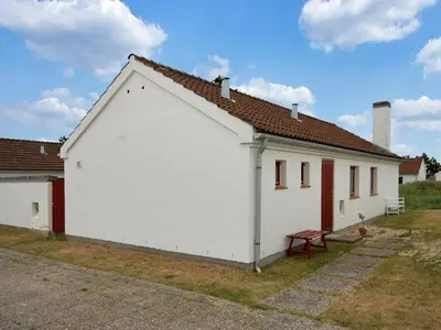 a large white building with a red door at Holiday Home Frieda - 7-2km from the sea by Interhome in Pandrup