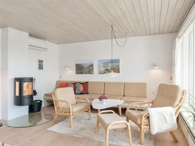 a living room with a couch and chairs and a table at Holiday Home Ara - 700m from the sea by Interhome in Pandrup