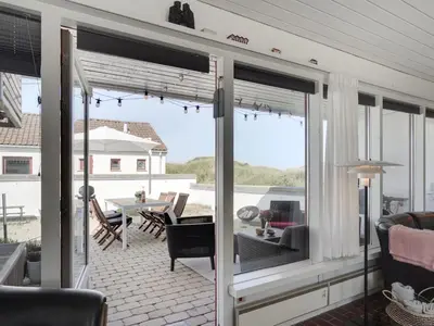 a screened in porch with a view of the patio at Holiday Home Marjon - 400m from the sea by Interhome in Pandrup