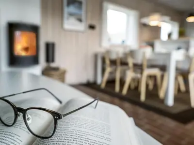 a pair of glasses sitting on top of an open book at Holiday Home Emiljan - 400m from the sea by Interhome in Pandrup