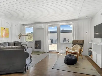 a living room with a couch and a chair at Holiday Home Ingomar - 300m from the sea by Interhome in Pandrup
