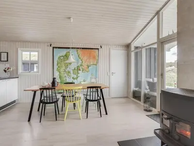 a kitchen with a table and chairs in a room at Holiday Home Driss - 500m from the sea by Interhome in Pandrup