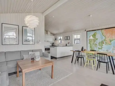 a living room with a couch and a table at Holiday Home Driss - 500m from the sea by Interhome in Pandrup