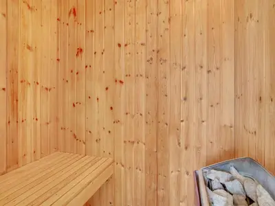 a wooden paneled sauna with a bench in it at Holiday Home Zaharinka - 300m from the sea by Interhome in Pandrup