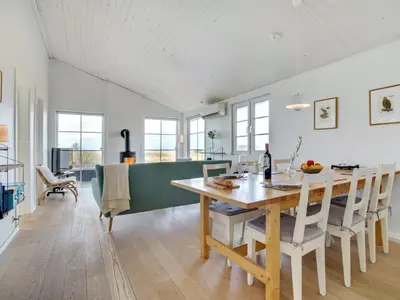 a kitchen and dining room with a table and chairs at Holiday Home Zaharinka - 300m from the sea by Interhome in Pandrup