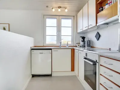 a kitchen with white appliances and a window at Holiday Home Zaharinka - 300m from the sea by Interhome in Pandrup