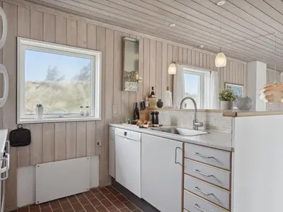 a kitchen with a sink and a window at Holiday Home Viena - 400m from the sea by Interhome in Pandrup