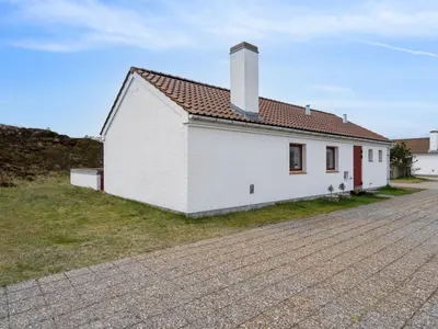 a white building with a chimney on a street at Holiday Home Viena - 400m from the sea by Interhome in Pandrup