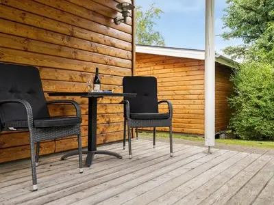 three chairs and a table on a deck at Holiday Home Krister - 250m to the fjord by Interhome in Farsø