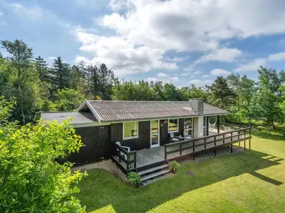 a house with a large deck in the yard at Holiday Home Angantir - 700m to the fjord by Interhome in Løgstør