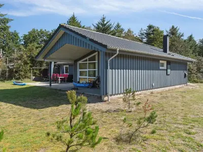 a small house with a patio and a yard at Holiday Home Awenita - 50m to the fjord by Interhome in Løgsted