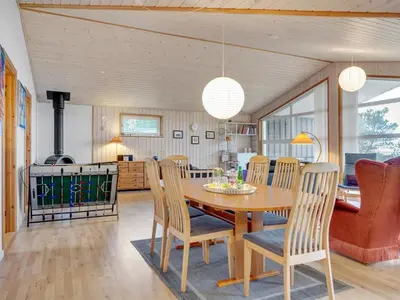 a kitchen and dining room with a table and chairs at Holiday Home Awenita - 50m to the fjord by Interhome in Løgsted