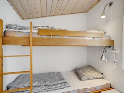 a bedroom with two bunk beds in a room at Holiday Home Githa - 100m to the fjord by Interhome in Løgstør