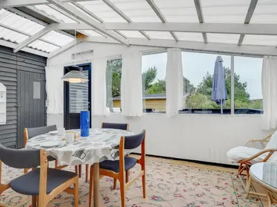 a dining room with a table and chairs at Holiday Home Githa - 100m to the fjord by Interhome in Løgstør