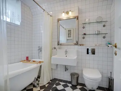 a bathroom with a sink toilet and a mirror at Holiday Home Tamer - 500m to the fjord by Interhome in Farsø