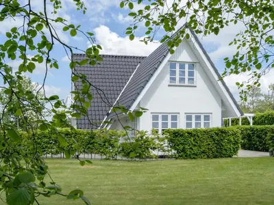 a white house with a gambrel roof at Holiday Home Tamer - 500m to the fjord by Interhome in Farsø