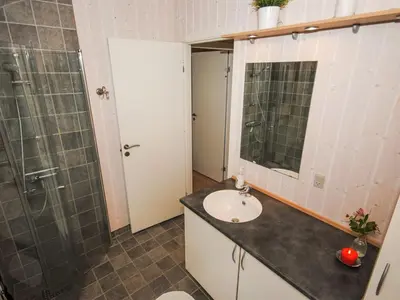 a bathroom with a sink and a shower at Holiday Home Evelina - 150m to the fjord by Interhome in Løgsted