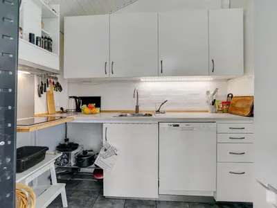 a white kitchen with white cabinets and a sink at Holiday Home Marlien - 1km to the fjord by Interhome in Løgsted
