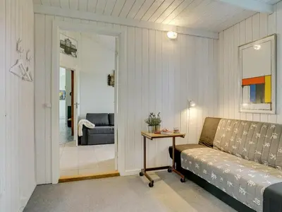 a living room with a couch and a table at Holiday Home Marlien - 1km to the fjord by Interhome in Løgsted