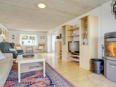 a living room with a couch and a tv at Holiday Home Yorrick - 50m to the fjord by Interhome in Løgstør