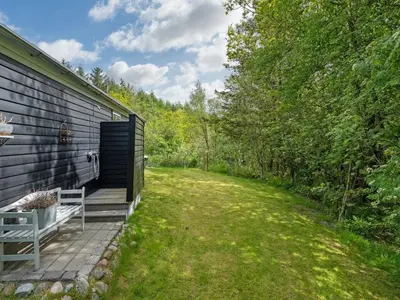 a back yard of a house with a bench at Holiday Home Eireen - 600m to the fjord by Interhome in Farsø