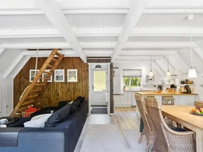 a living room with a couch and a table at Holiday Home Jütte - 2km to the fjord by Interhome in Farsø