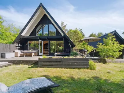 a small house with a roof that has a patio at Holiday Home Jütte - 2km to the fjord by Interhome in Farsø