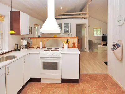 a kitchen with white cabinets and a stove top oven at Holiday Home Gesina - 600m to the fjord by Interhome in Løgstør