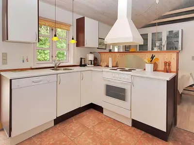 a kitchen with white cabinets and a stove top oven at Holiday Home Gesina - 600m to the fjord by Interhome in Løgstør