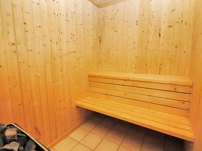 a sauna with a wooden bench in a room at Holiday Home Gesina - 600m to the fjord by Interhome in Løgstør