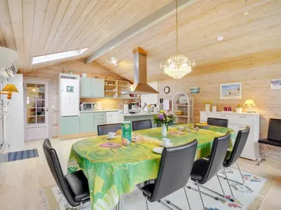 a kitchen and dining room with a table and chairs at Holiday Home Magh by Interhome in Års