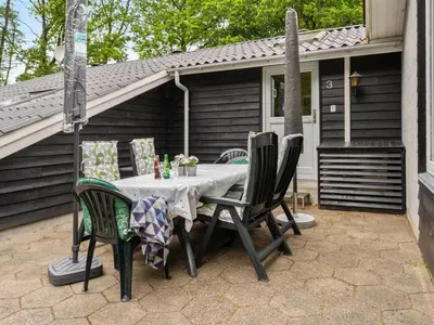 a table and chairs sitting on a patio at Holiday Home Magh by Interhome in Års