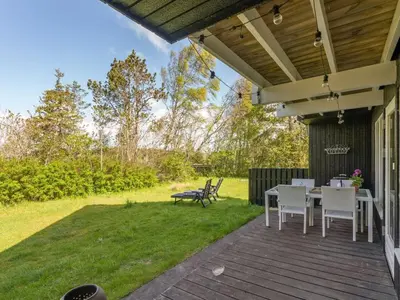 a patio with a table and chairs on a deck at Holiday Home Thina - 750m to the fjord by Interhome in Løgsted