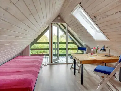 a bedroom with a bed and a desk in a room at Holiday Home Valo - 400m to the fjord by Interhome in Løgsted