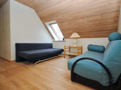 a living room with a couch and a chair at Holiday Home Millie - 3km to the fjord by Interhome in Løgstør