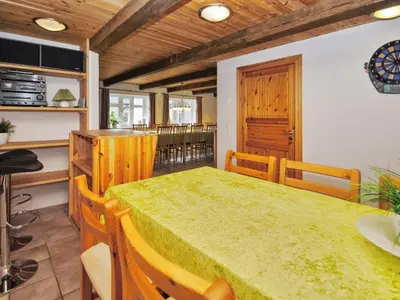 a dining room with a green table and chairs at Holiday Home Millie - 3km to the fjord by Interhome in Løgstør