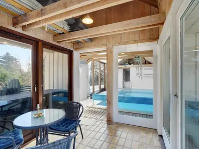 a room with a patio with a table and chairs at Holiday Home Waldar - 900m from the sea by Interhome in Fjerritslev
