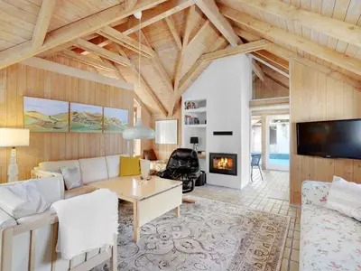 a living room with a couch and a fireplace at Holiday Home Waldar - 900m from the sea by Interhome in Fjerritslev
