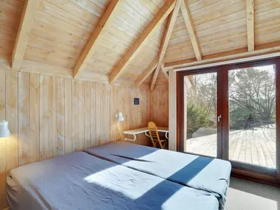 a bedroom with a bed in a room with a large window at Holiday Home Waldar - 900m from the sea by Interhome in Fjerritslev