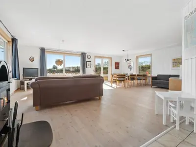 a living room with a couch and a table at Holiday Home Alvira - 8km to the fjord by Interhome in Fjerritslev