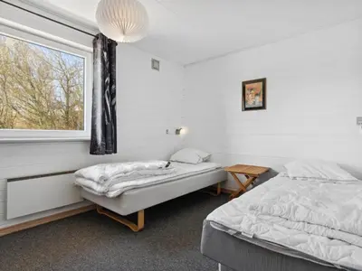 a bedroom with two beds and a window at Holiday Home Alvira - 8km to the fjord by Interhome in Fjerritslev