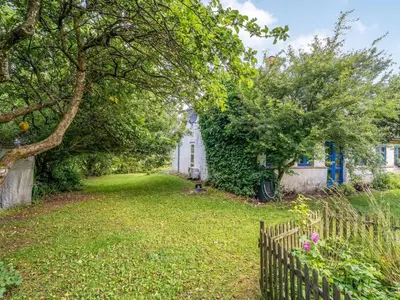 a yard with a fence and trees and a house at Holiday Home Agrippa - 30m to the fjord by Interhome in Løgstør