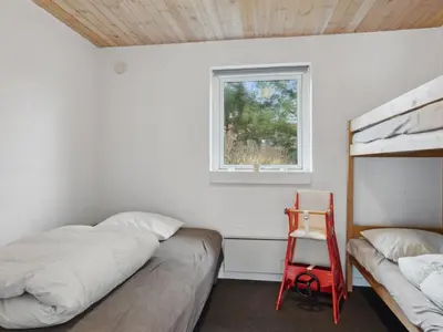 a bedroom with two bunk beds and a window at Holiday Home Justine - 600m from the sea by Interhome in Fjerritslev