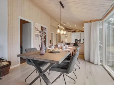 a dining room with a long table and chairs at Holiday Home Sighbiorn - 950m from the sea by Interhome in Fjerritslev