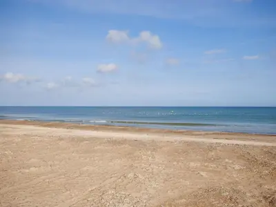 a sandy beach with the ocean in the background at Holiday Home Ordan - 800m from the sea by Interhome in Fjerritslev
