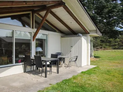 a patio with a table and chairs on a house at Holiday Home Oberon - 3km from the sea by Interhome in Fjerritslev
