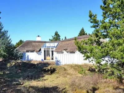 a house on top of a hill with trees at Holiday Home Roulf - 1-1km from the sea by Interhome in Fjerritslev